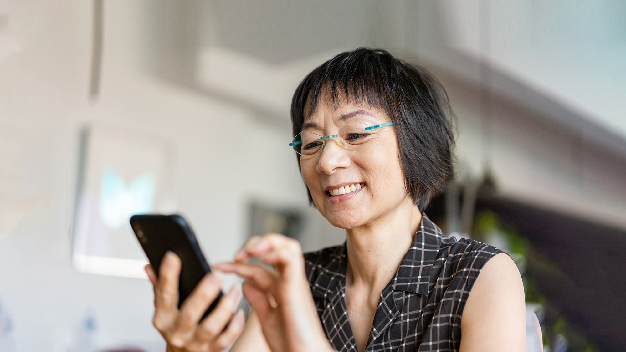 Asian woman using phone safely